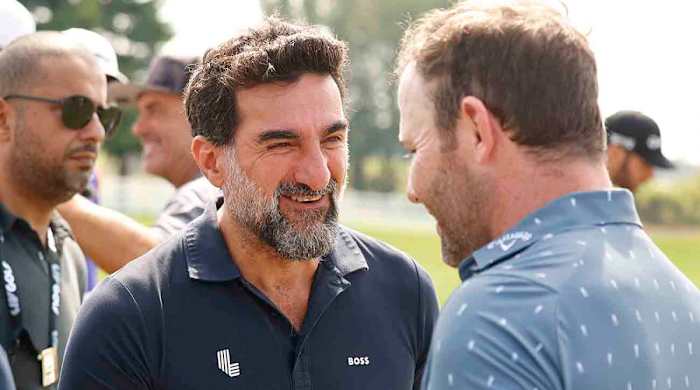 Yasir Al-Rumayyan, governor of Saudi Arabia s Public Investment Fund, talks with player Branden Grace on the practice range before the start of the second round of the 2022 LIV Golf Invitational Series Chicago.
